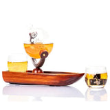 Don Vassie globe decanter set with 2 glasses and a boat shaped mahogany wooden base